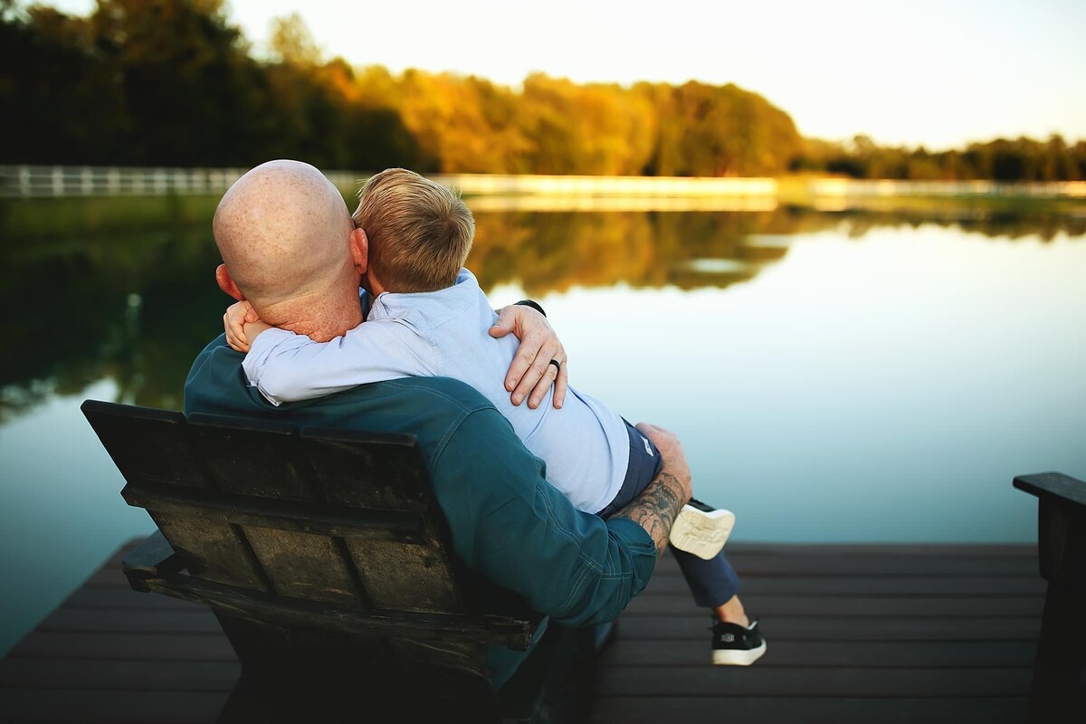Father and son sharing a quiet moment by the pond at Parkton Place