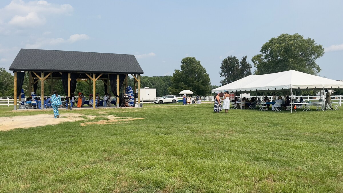 Guests gathered under the pavilion and tent for an event at Parkton Place
