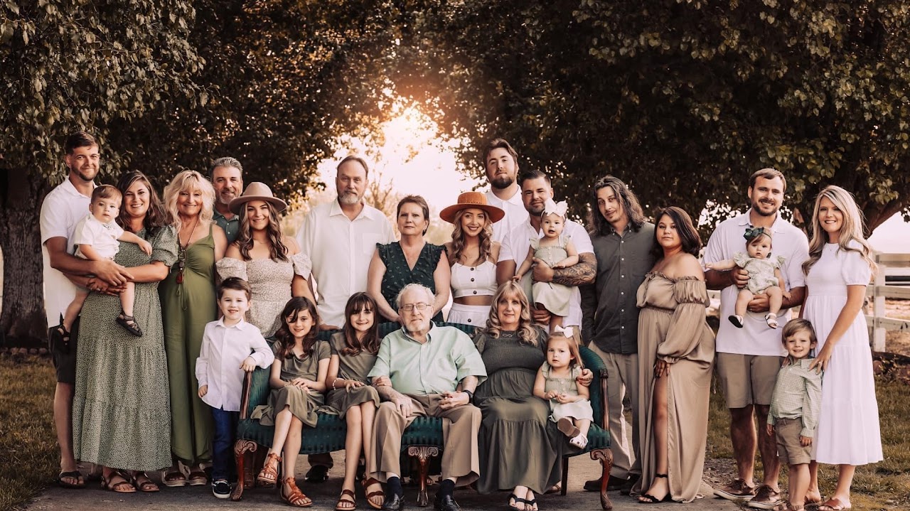 A family gathered outdoors at Parkton Place at golden hour